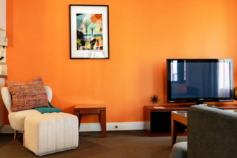 Bright coloured walls and artwork set up the space.