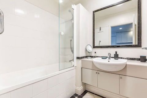 There is a full bathtub that is a luxury in an apartment.