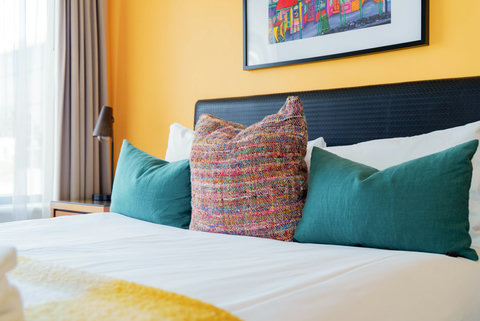 There are large windows in the bedroom which lets lots of light in and drapes to keep it out at night.