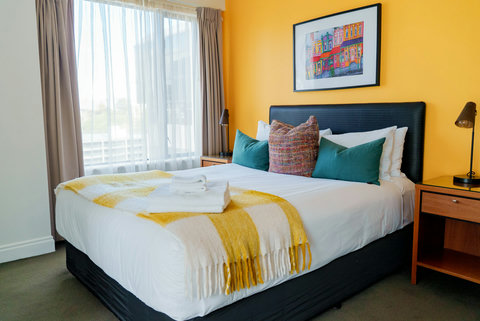 The throw matches the wall and makes it feel happy with its bright yellow features.