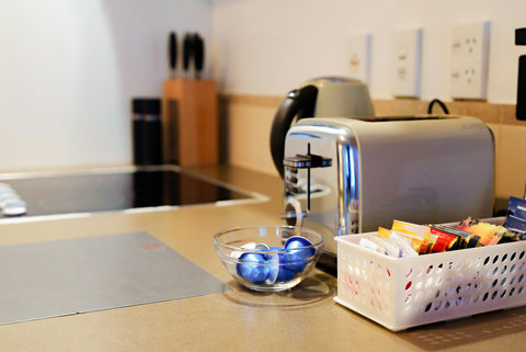 There is a selection of teas provided along with coffee and sugar.