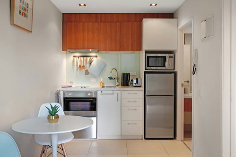 The kitchen may be compact, but it has everything you need to create a meal, including a cooktop, oven, dish drawer, microwave and fridge/freezer.