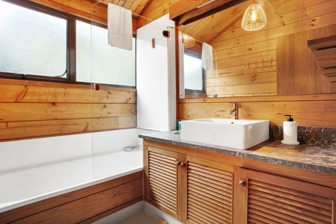 The family bathroom has a bath, a handheld shower attachment, and a large vanity unit.