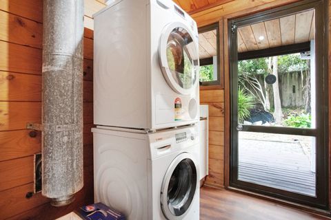 There is a washing machine and dryer in a separate laundry area.