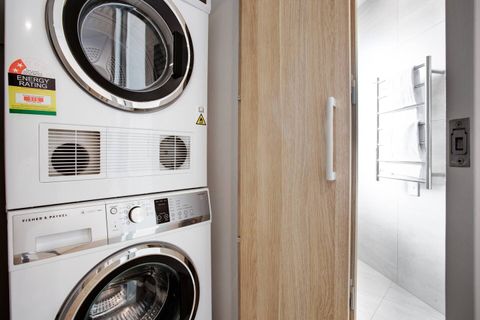 There is a washing machine and dryer in the laundry area.
