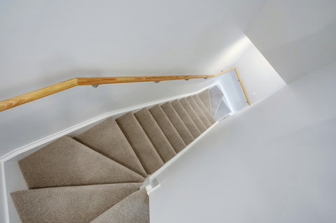 The stairs from the ground floor to the top floor - note the stairs curve slightly at the top and bottom.