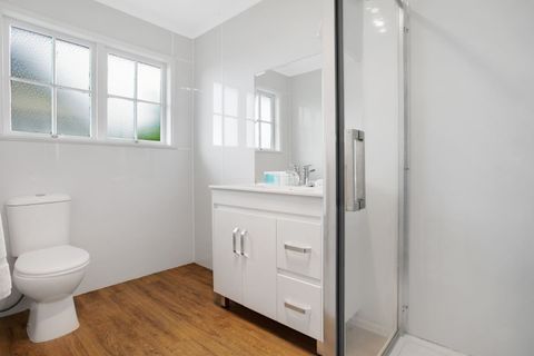 The bathroom has a shower, vanity unit and toilet.