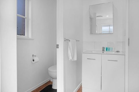 The bathroom has been updated with modern fixtures and wooden floors.
