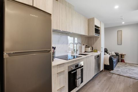 The kitchen has a cook top, oven, dishwasher, microwave and fridge/freezer.