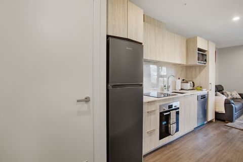 The laundry facilities are in the kitchen area behind the door.