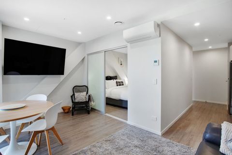 The bedroom is through the frosted door off the living spaces.