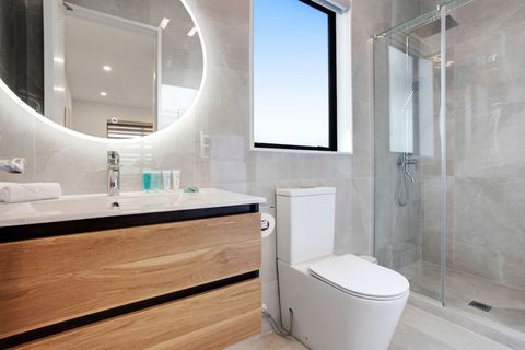 The ensuite bathroom has a shower, toilet and vanity unit.