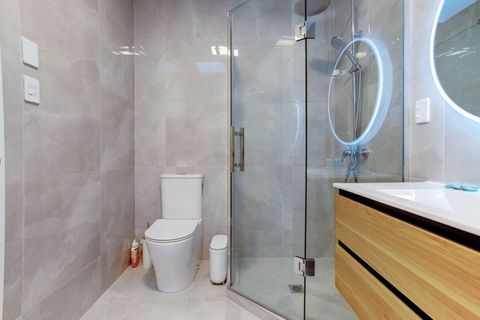 The main bathroom has a toilet, shower and vanity unit.