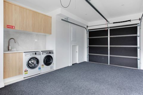 The front-loading washing machine and dryer is located in the garage.