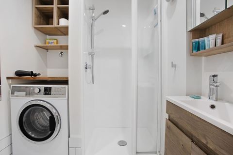 The combo washer and dryer is located in the bathroom.