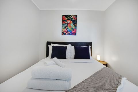 The bright colourful artwork adds a pop of colour to the bedroom.