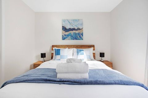 With blue accents in the throw, cushions and artwork, this bed invites you to sleep under the crisp white sheets.