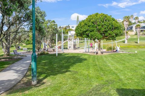 There is a children's playground and fields by the beach.