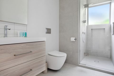 The family bathroom has a shower, toilet and vanity unit.