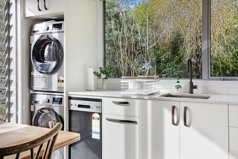 The washing machine and dryer are located in the kitchen area.