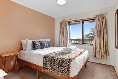 With mixed colour cushions and a brown textured throw, this bed invites you to sleep under the crisp white sheets.