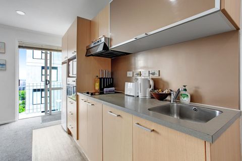 The kitchen has a cooktop, oven, microwave, dishwasher and fridge/freezer.