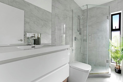 The bathroom has a shower, toilet, vanity and heated towel rail.