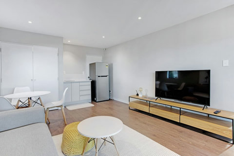 The open-plan view of the guest suite with the kitchenette, dining area, and living space.