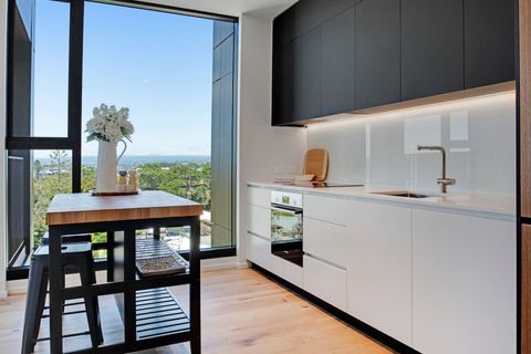 Sit at the kitchen island and enjoy the view over towards Hobsonville.