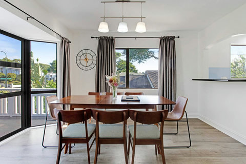 The dining table is close to the kitchen and the living room.