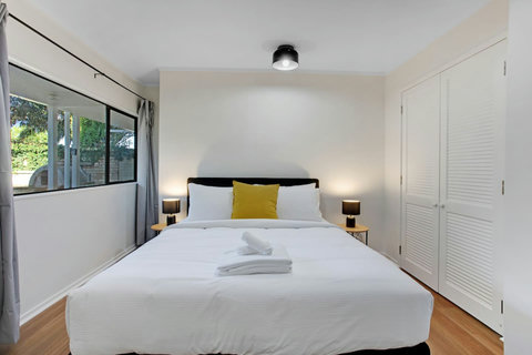 There is plenty of natural light that streams into the bedroom through the windows.