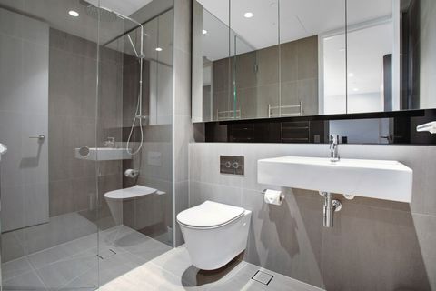 The bathroom has a shower, toilet and basin plus lots of storage in the mirrored cupboards.