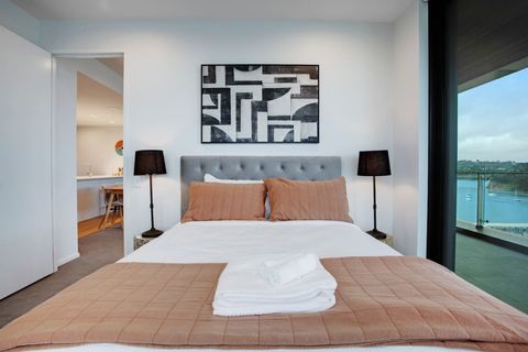 The Queen bed looks inviting and comfortable with its neutral colours.