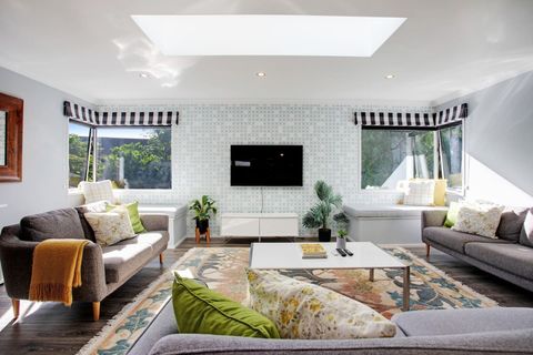 There is plenty of natural light that streams into this living area through the windows and the skylight.