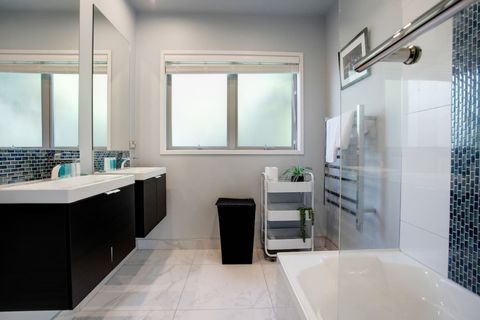 The family bathroom has a shower and tub option with double vanities and a separate toilet room.
