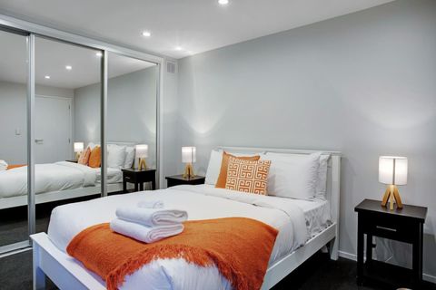 The double bed has lovely pops of orange in the throw and cushions.