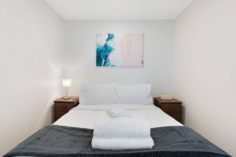 This bed invites you to sleep under the crisp white sheets.