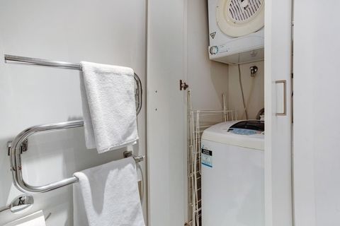The washer and dryer is located in the bathroom.