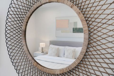The mirror adds some interest and light diffusion to the room.
