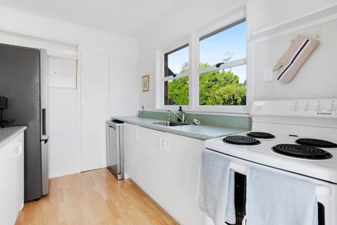 The kitchen has an oven, cooktop, dishwasher, microwave and fridge/freezer.