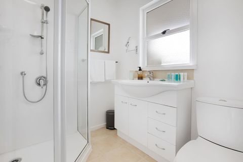 The bathroom has a shower, vanity, and toilet.