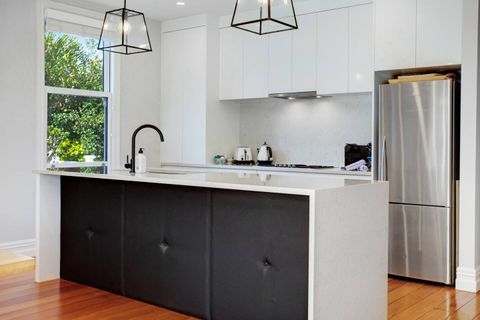 The kitchen is a striking black and white colour scheme.