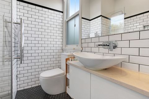 The ensuite bathroom has a shower, toilet and vanity unit.