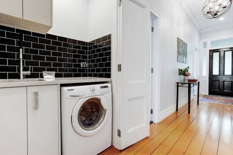 The combo washer and dryer is located in the hallway cupboard.