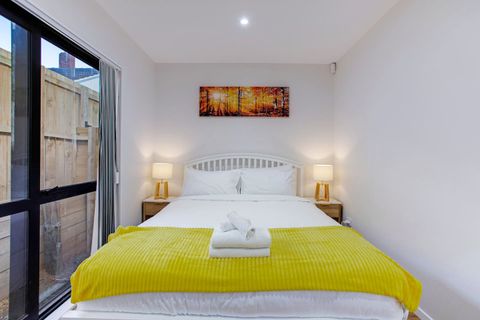 The downstairs bedroom has a queen bed, two bedside cabinets and a single wardrobe.