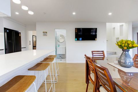 The TV is wall mounted so can be watched from any of the living spaces.