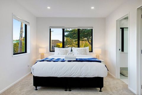 The King bed has a bright blue and white throw.