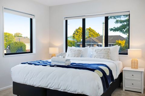 The King-sized bed in the Main bedroom is framed by the window.