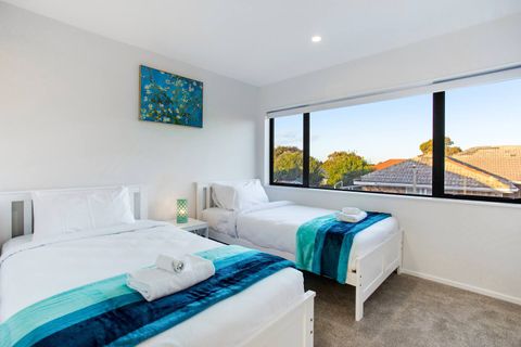 The blue throws add a splash of colour to a neutral colour scheme.