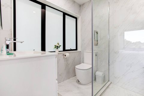 The ensuite bathroom has a toilet, shower and vanity unit.